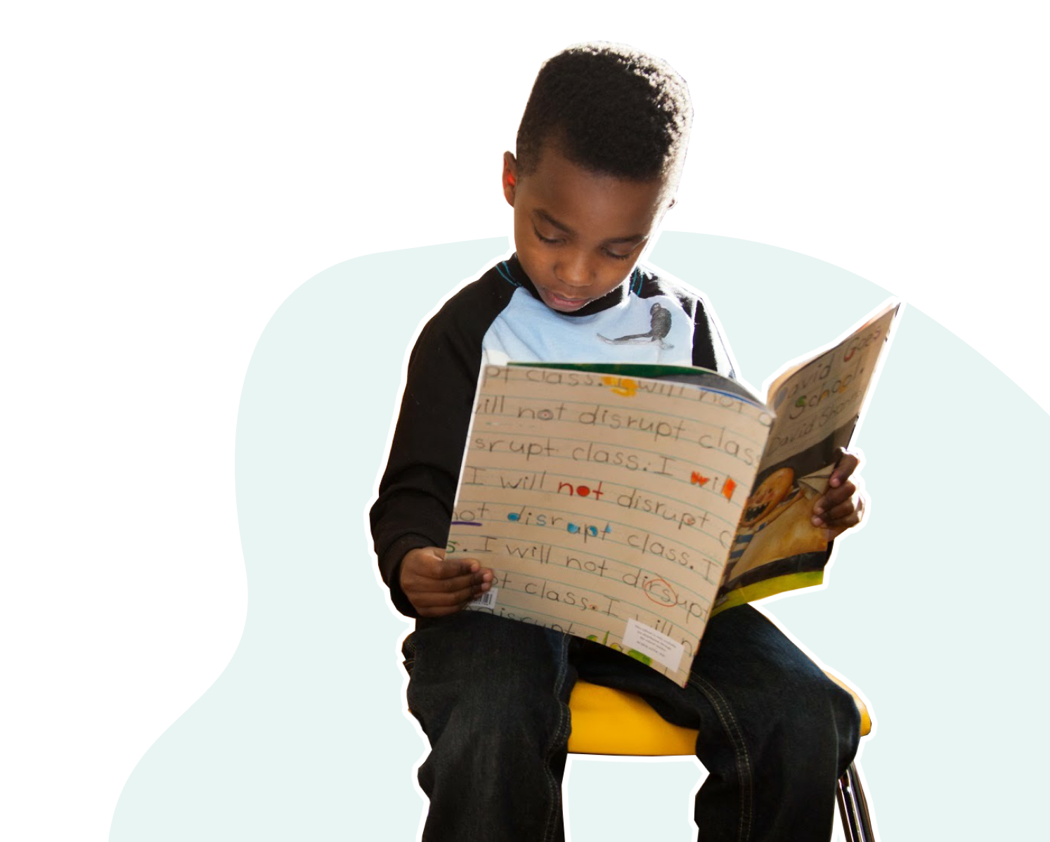 Black boy reading a book at the barbershop