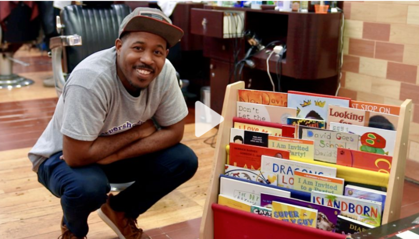 Man squatting next to a children's book shelf